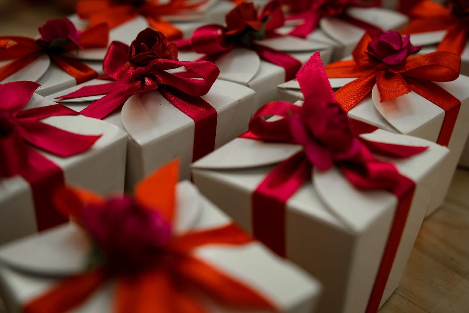 White gift boxes tied with red and orange ribbons